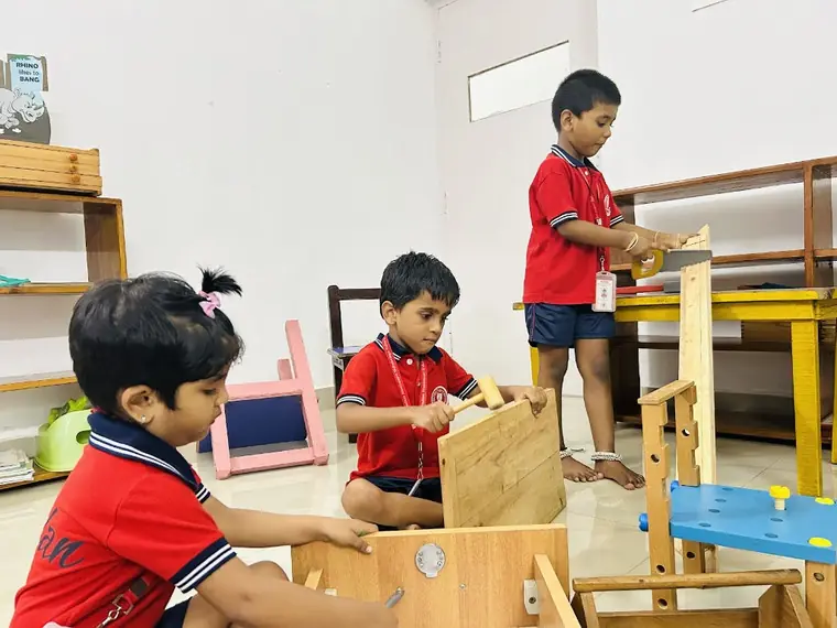 Young KIMS children building with wooden pieces