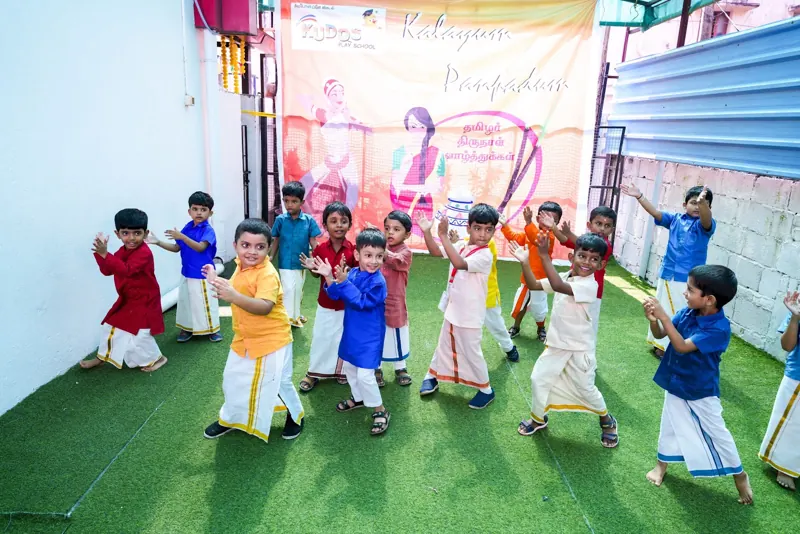 Children in traditional clothes dancing at the KIMS Pongal celebration